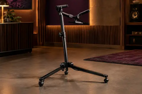 Support Hercules DS561B en métal noir, déployé sur le sol d’un studio de répétition sobre.