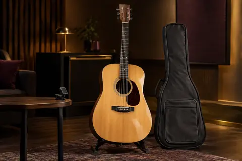 Guitare acoustique Martin Smith en bois naturel sur un support, avec housse et accessoires disposés à proximité
